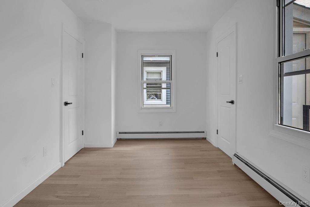 173-62 103rd Road Queens, NY 11433 - Photo 16 of 23 a view of an empty room with a window
