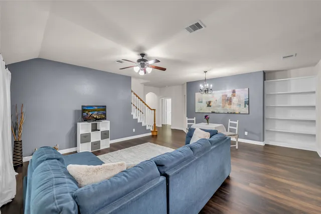 a living room with furniture and wooden floor