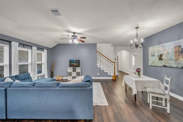 a living room with furniture and wooden floor