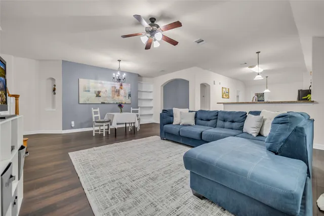 a living room with furniture and a chandelier