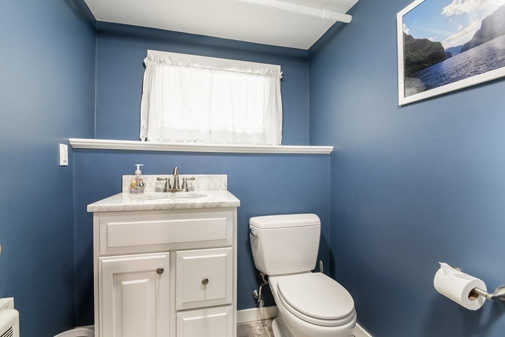 105 Sutton Road Needham, MA 02492 - Photo 25 of 38 a bathroom with a toilet a sink and a window
