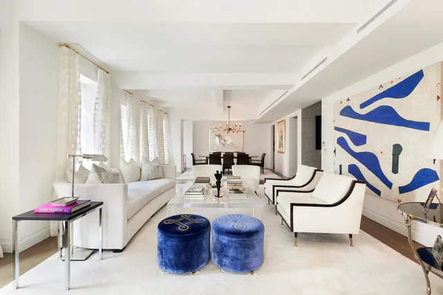 a living room with furniture and white walls