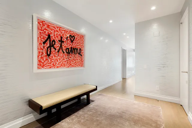 a hallway with a large mirror and a couch