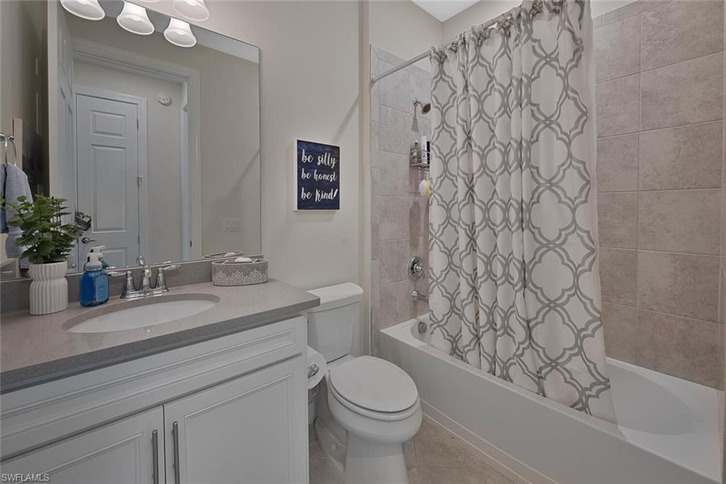 10709 Manatee Key Lane Estero, FL 33928 - Photo 12 of 18 a bathroom with a granite countertop sink toilet and shower