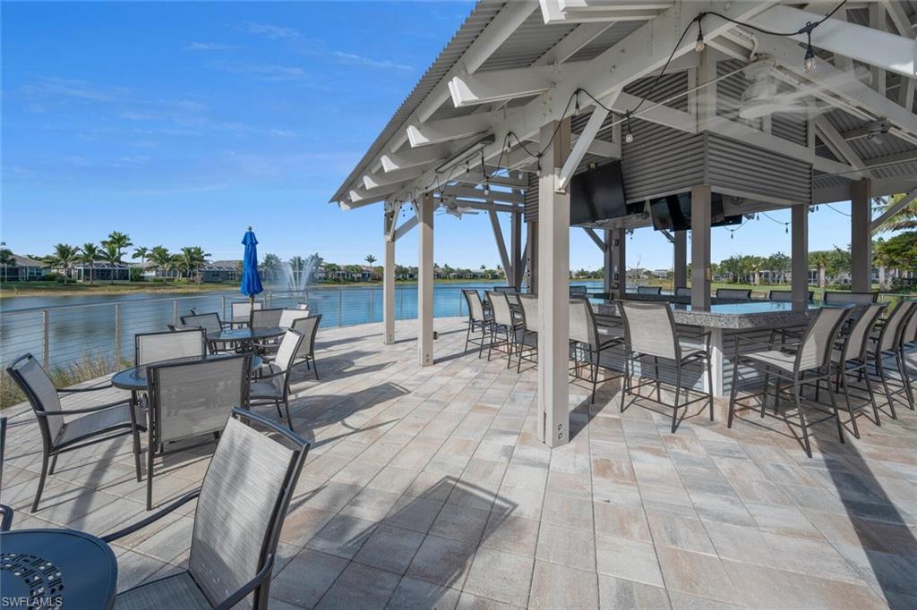 10709 Manatee Key Lane Estero, FL 33928 - Photo 15 of 18 a view of a patio with a table chairs and a backyard