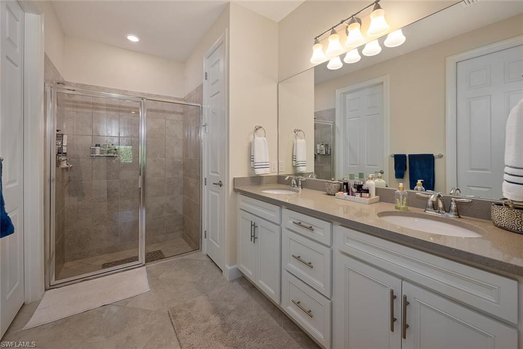 10709 Manatee Key Lane Estero, FL 33928 - Photo 10 of 18 a bathroom with double sink and a mirror