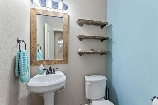 a bath tub sitting in a bathroom next to a sink