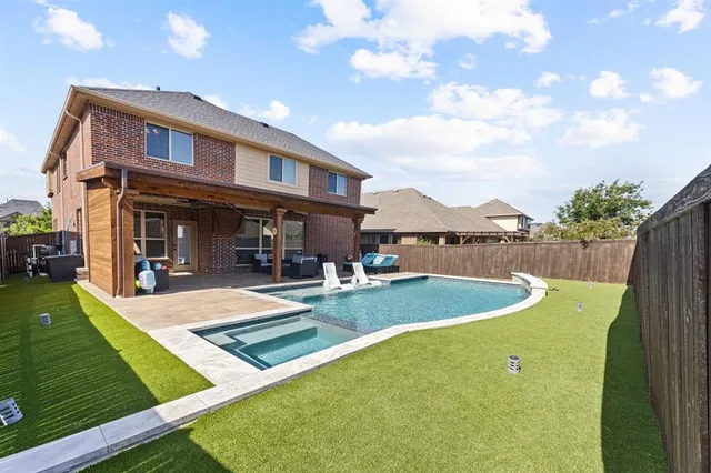 a view of a house with swimming pool and sitting area