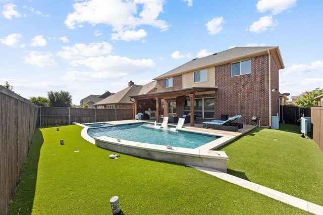 a view of a backyard with a small pool