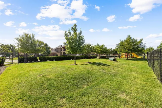 a view of a swimming pool with a table and chairs under an umbrella