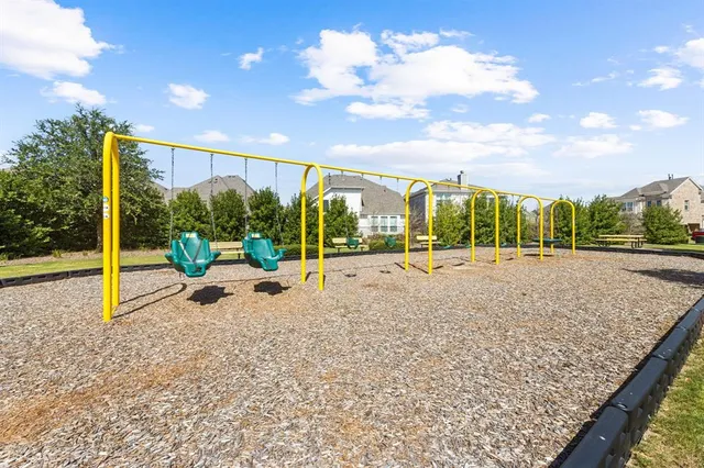 a view of tall trees and a park