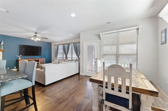 a kitchen with cabinets stainless steel appliances and a wooden floor