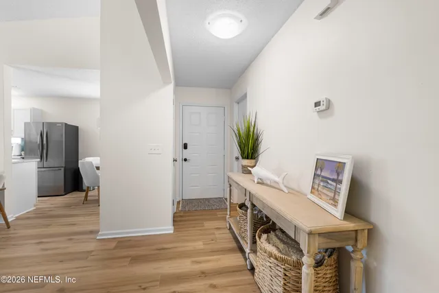 a view of an entryway with wooden floor