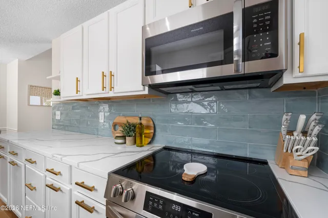 a kitchen with a stove and a microwave
