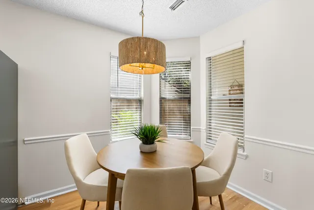 a dining room with furniture and window