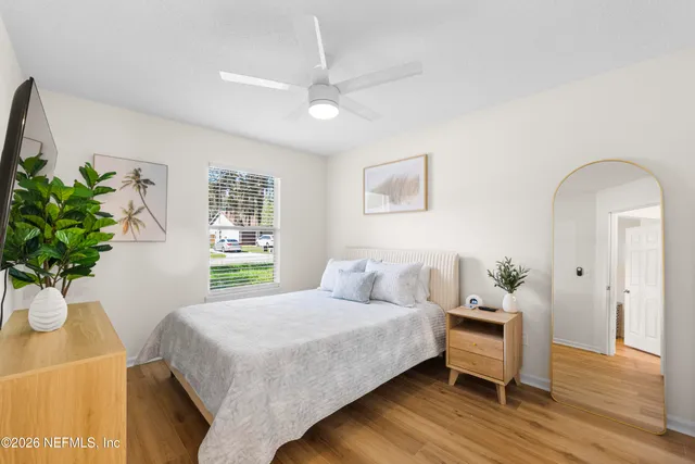 a bedroom with a bed and a potted plant