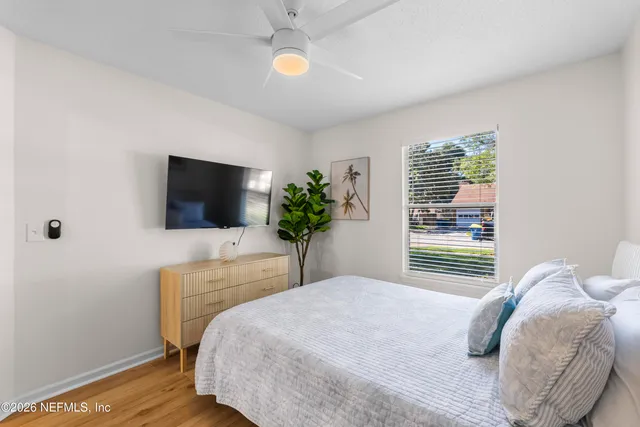 a bedroom with a large bed and a flat screen tv