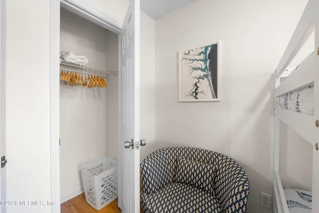 a bedroom with a bed and painting on the wall