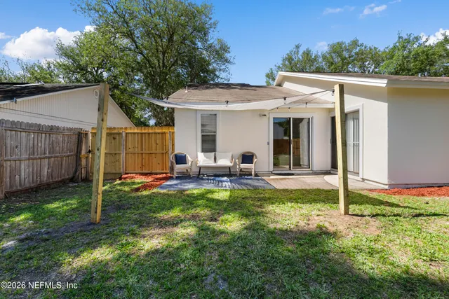 a view of a house with backyard and porch