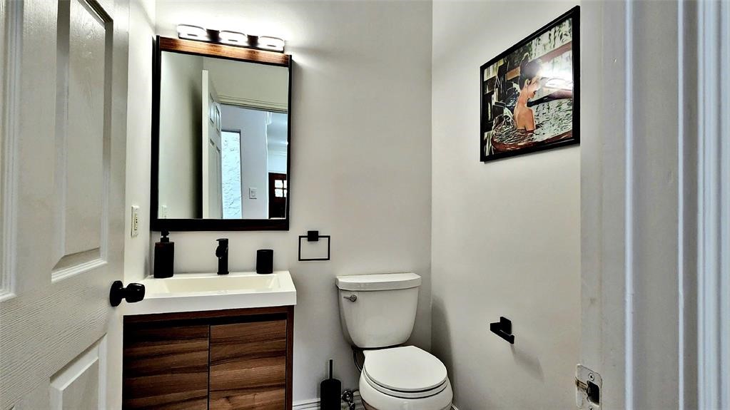 6726 Buffalo Speedway Houston, TX 77005 - Photo 12 of 30 a bathroom with a toilet a sink and mirror