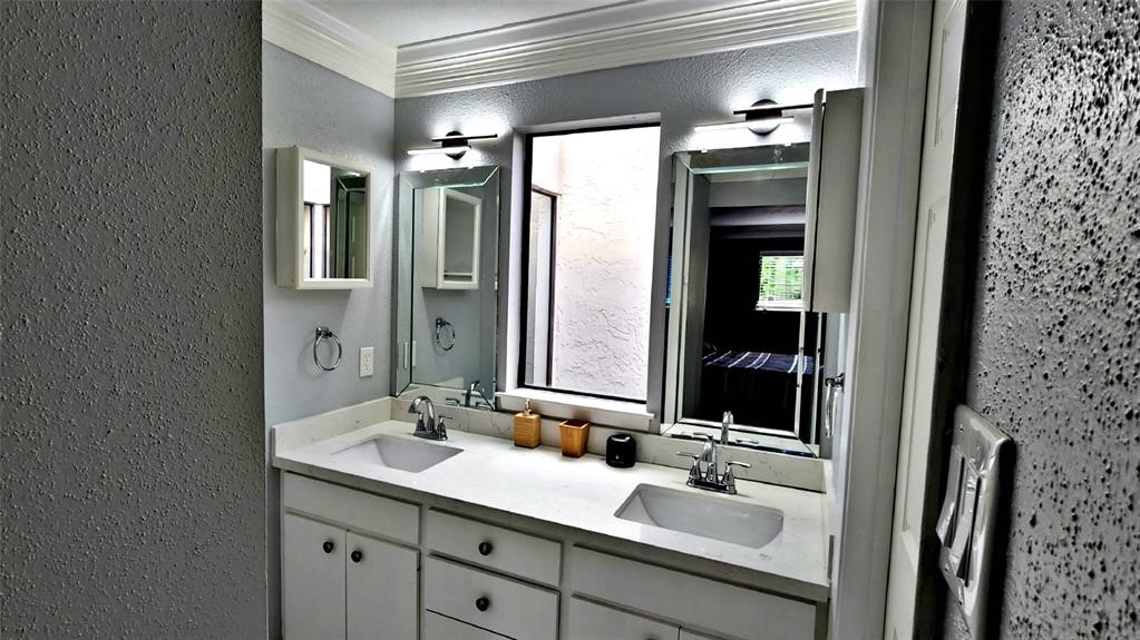 6726 Buffalo Speedway Houston, TX 77005 - Photo 21 of 30 a bathroom with a double vanity sink and mirror