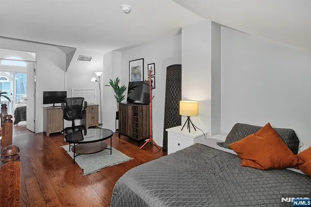 a bedroom with furniture and a gym equipment