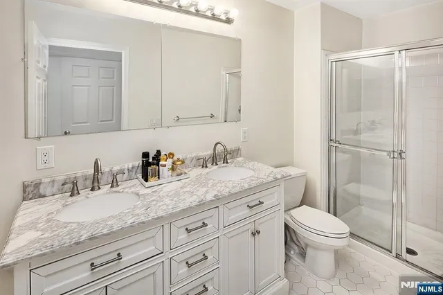 a bathroom with a granite countertop toilet sink and a mirror