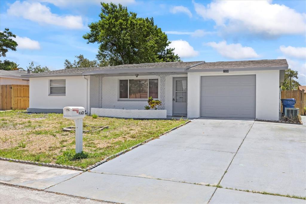 a view of a house with a backyard