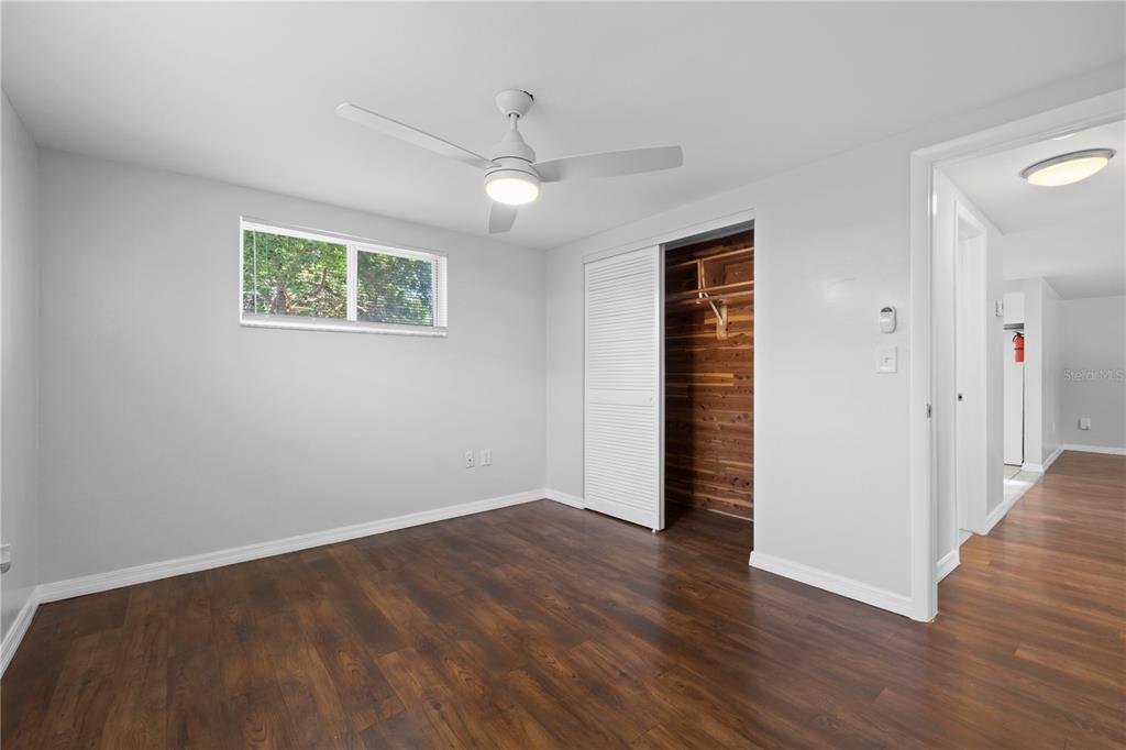 7330 Abalone Drive Port Richey, FL 34668 - Photo 11 of 49 an empty room with wooden floor cabinet and windows