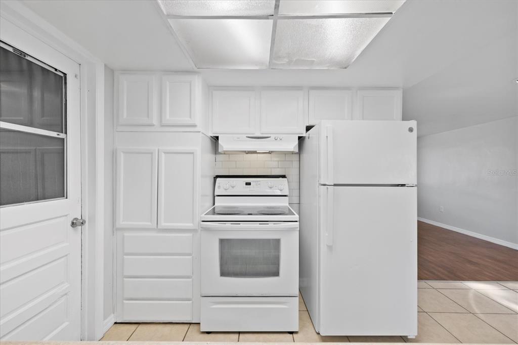 7330 Abalone Drive Port Richey, FL 34668 - Photo 20 of 49 a white refrigerator freezer and a stove sitting inside of a kitchen