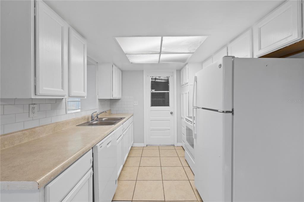 7330 Abalone Drive Port Richey, FL 34668 - Photo 21 of 49 a kitchen with a refrigerator and a sink