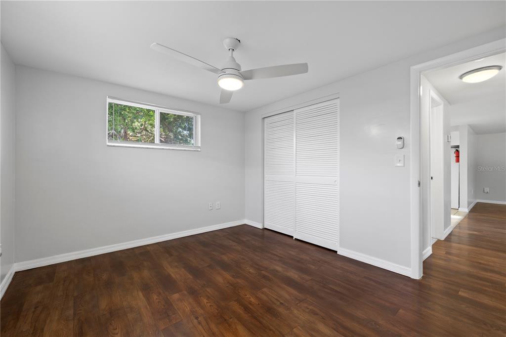 7330 Abalone Drive Port Richey, FL 34668 - Photo 22 of 49 a view of an empty room with wooden floor