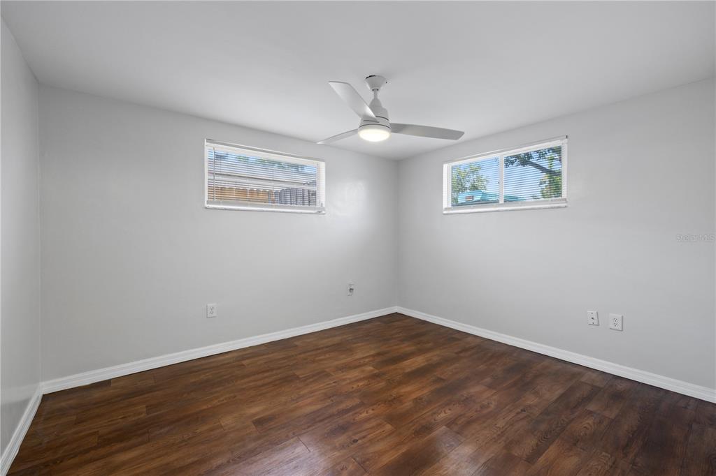 7330 Abalone Drive Port Richey, FL 34668 - Photo 24 of 49 a view of an empty room with wooden floor