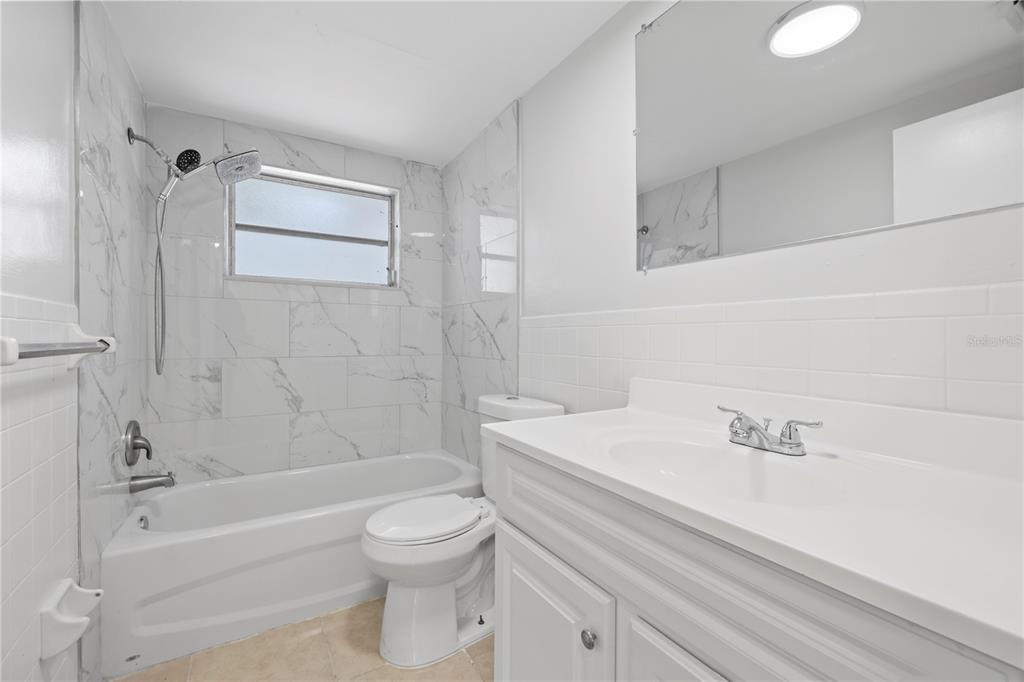 7330 Abalone Drive Port Richey, FL 34668 - Photo 3 of 49 a bathroom with a sink a toilet and a bathtub