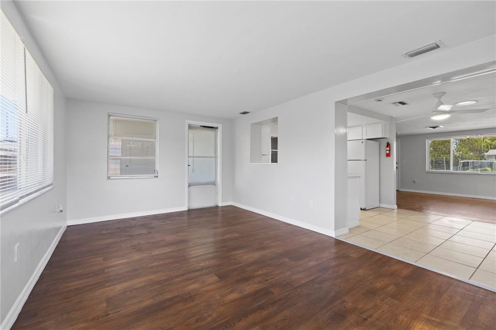 7330 Abalone Drive Port Richey, FL 34668 - Photo 31 of 49 wooden floor in an empty room with a window