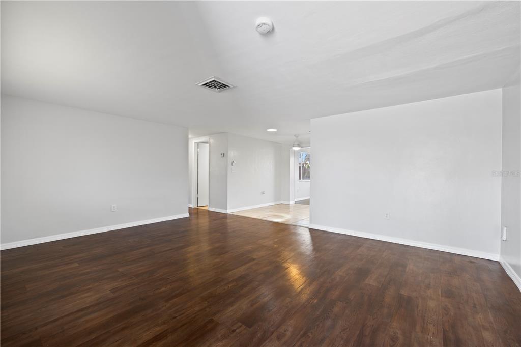 7330 Abalone Drive Port Richey, FL 34668 - Photo 34 of 49 a view of an empty room with wooden floor and a window