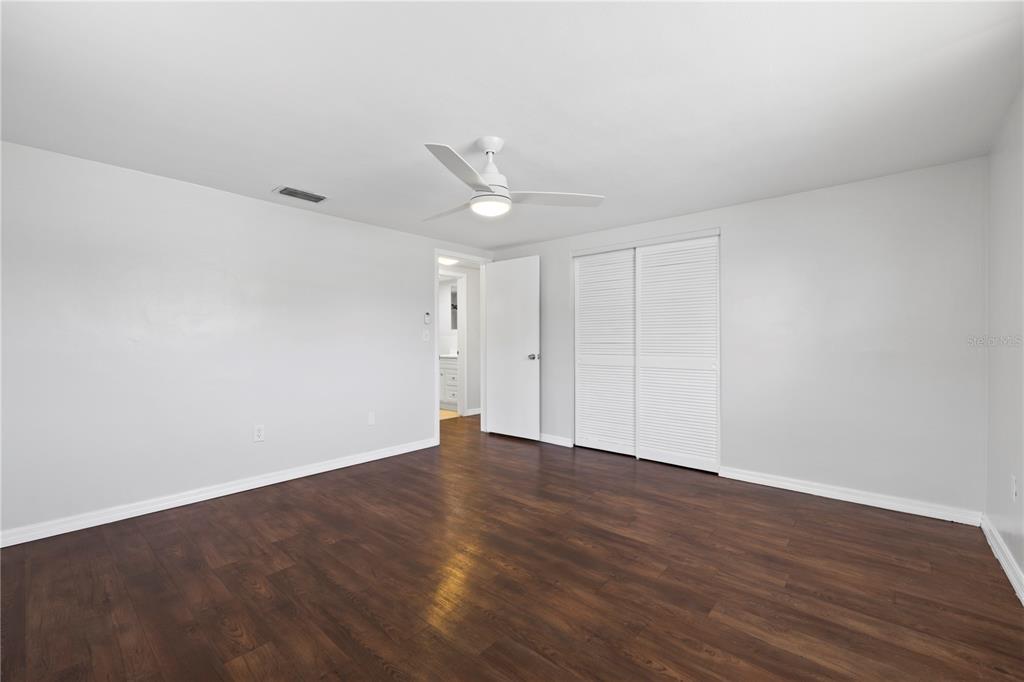 7330 Abalone Drive Port Richey, FL 34668 - Photo 37 of 49 a view of an empty room with wooden floor