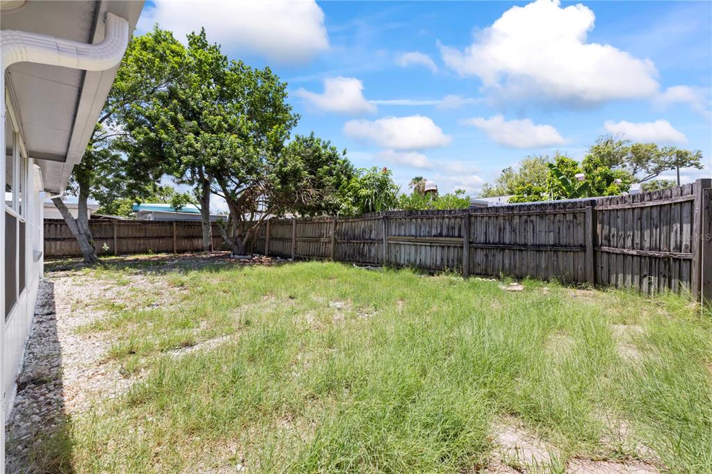 7330 Abalone Drive Port Richey, FL 34668 - Photo 41 of 49 a view of a backyard with a garden