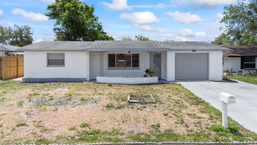7330 Abalone Drive Port Richey, FL 34668 - Photo 44 of 49 a view of house with yard and trees in the background
