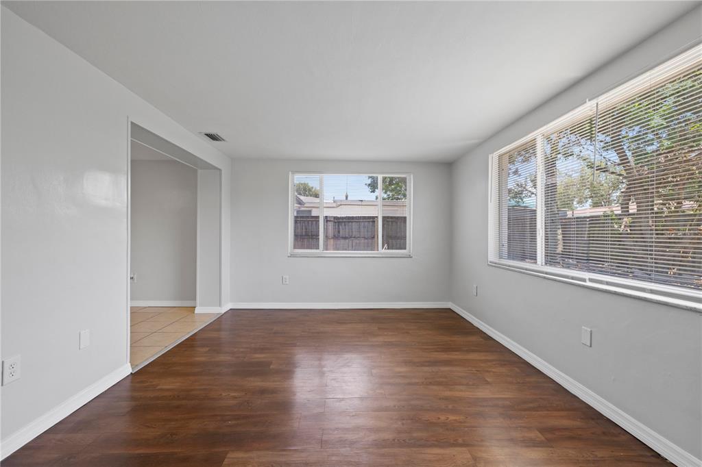 7330 Abalone Drive Port Richey, FL 34668 - Photo 5 of 49 an empty room with wooden floor and windows