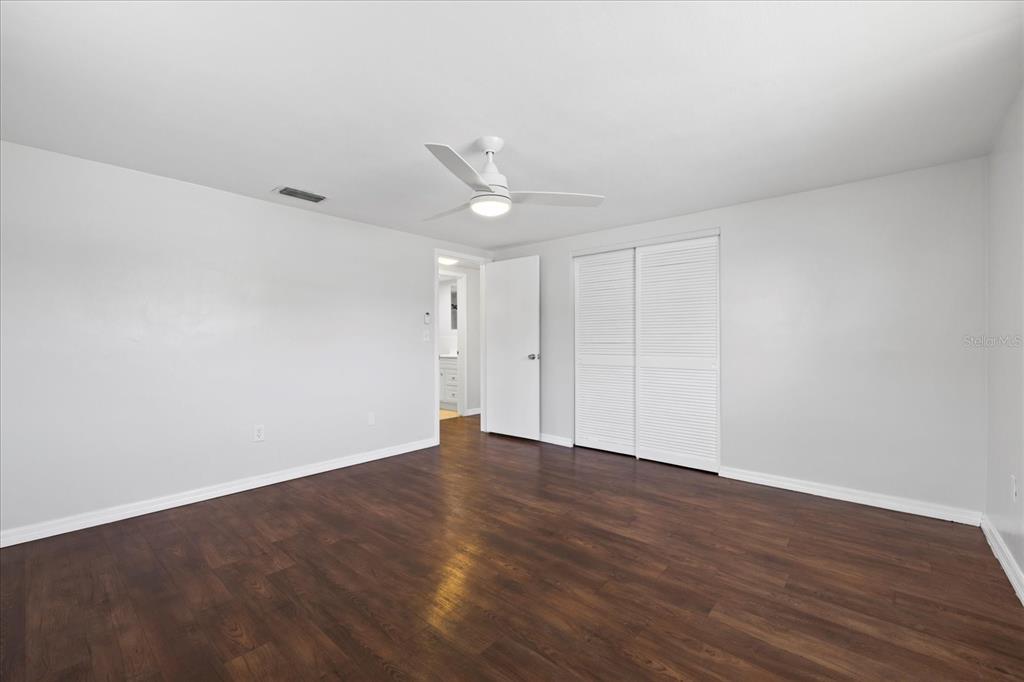 7330 Abalone Drive Port Richey, FL 34668 - Photo 9 of 49 a view of an empty room with wooden floor