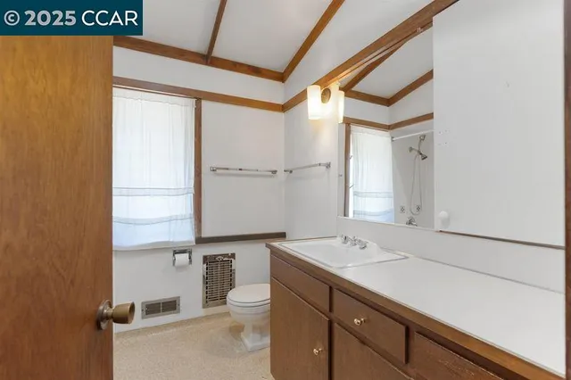 a white toilet sitting next to a bathroom sink