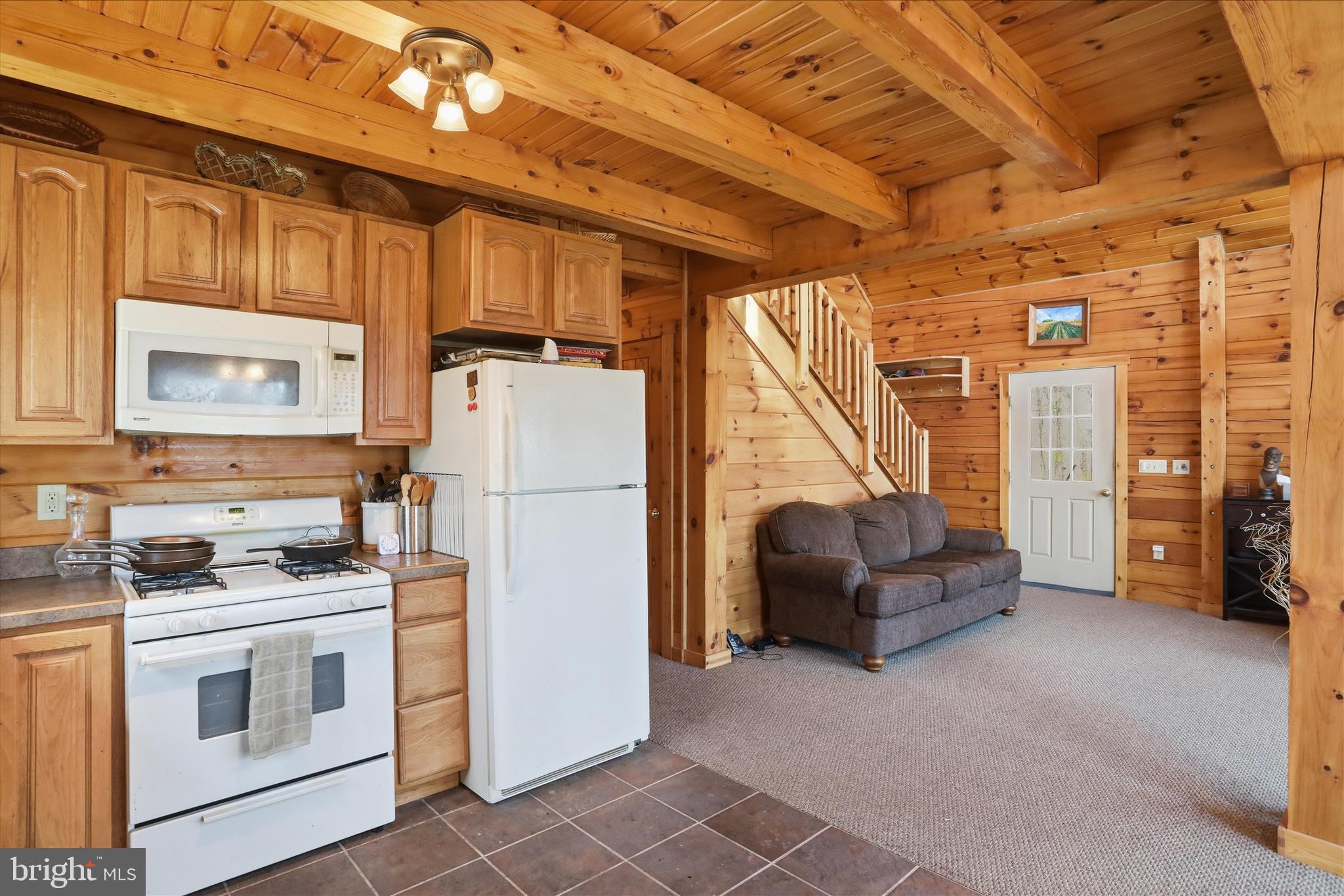 163 Olive Branch Road Rio, WV 26755 - Photo 20 of 70 a kitchen with refrigerator a stove a washer and dryer