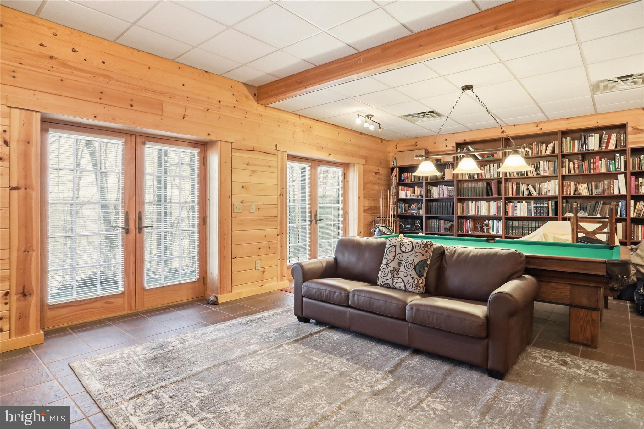163 Olive Branch Road Rio, WV 26755 - Photo 33 of 70 a living room with furniture and a floor to ceiling window