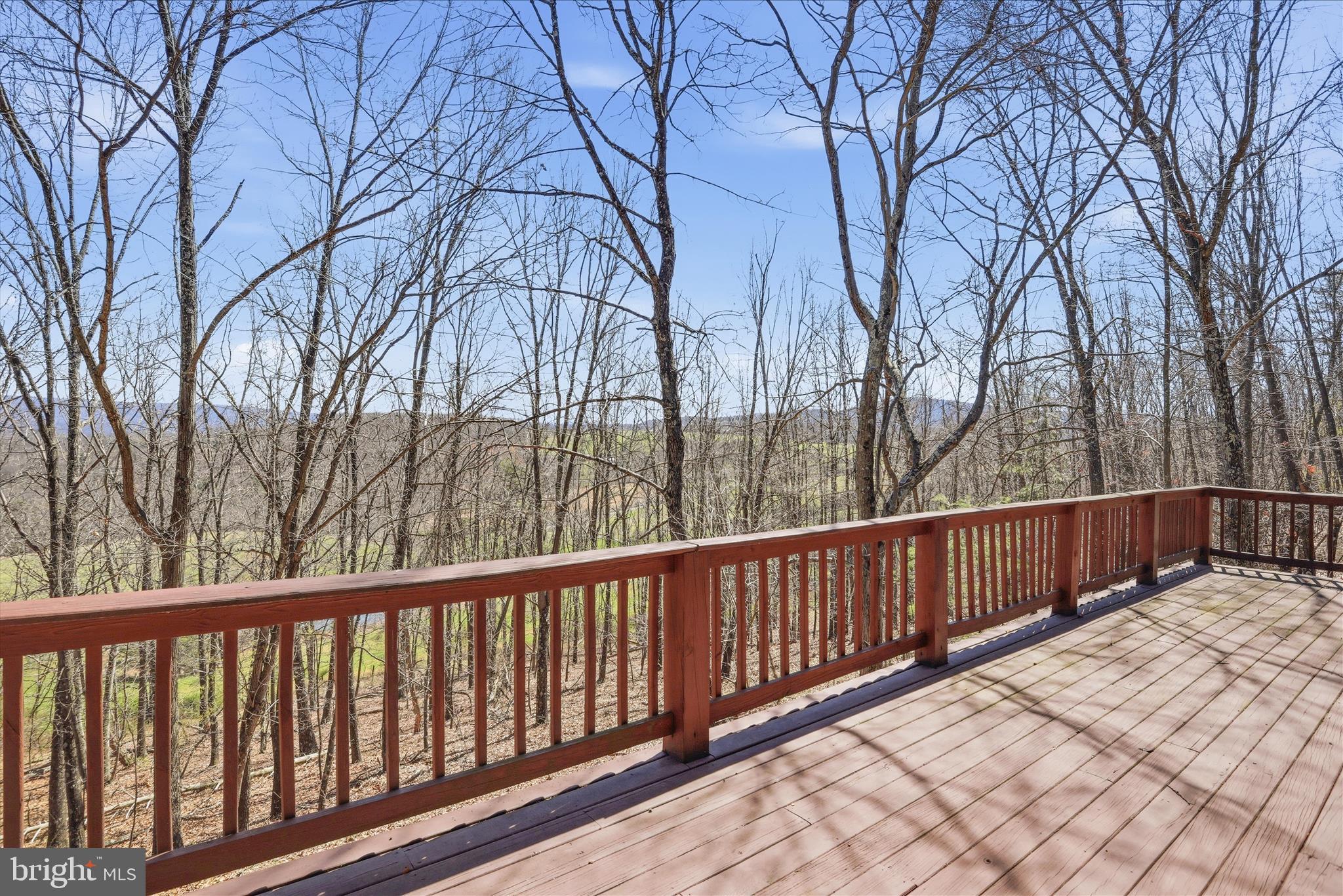 163 Olive Branch Road Rio, WV 26755 - Photo 39 of 70 a balcony with wooden fence and trees