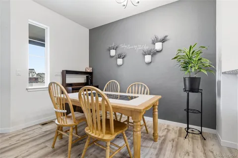 a view of a dining room with furniture and chandelier
