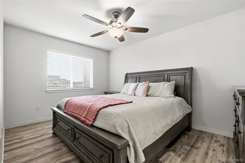 a bed room with a bed and a large window