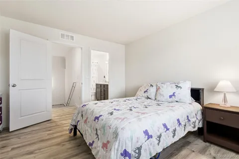 a bedroom with a bed and a lamp