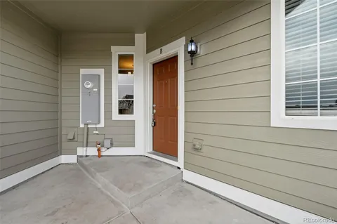 a view of a house with a wooden bench and door