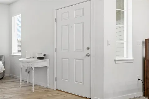 a view of a room that has a window and wooden floor